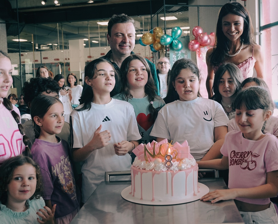 Happy family celebrating birthday with cake